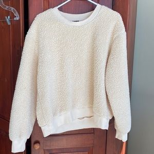 Fuzzy creamish/peachish shirt. Size medium.